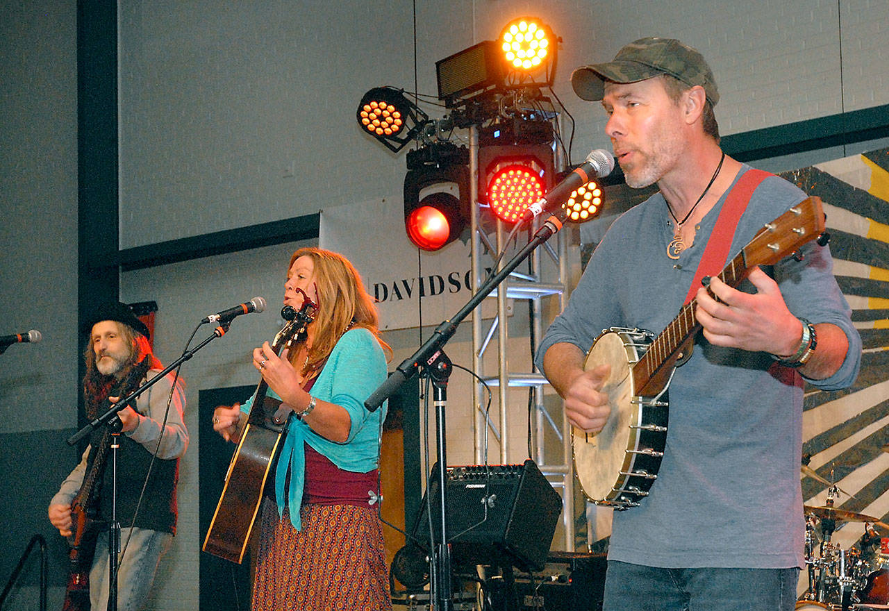 Members of Port Angeles-based Joy In Mudville, from left, Paul Stehr-Green, Kim Trenerry and Jason Mogi, entertain the audience on Friday from the Main Stage of the Juan de Fuca Festival of the Arts. (Keith Thorpe/Peninsula Daily News)