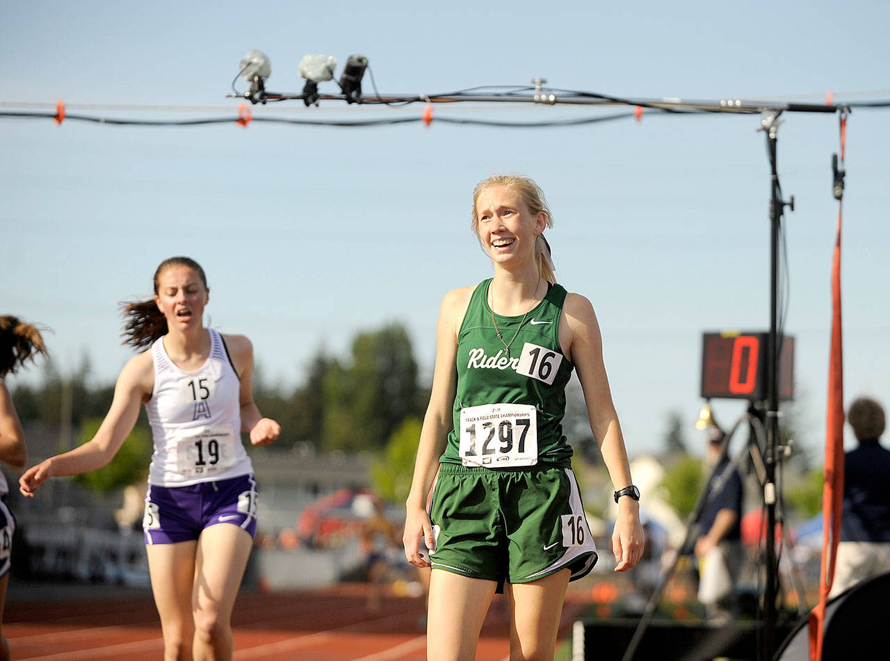 Port Angeles’ Gracie Long, right, reacts, after winning the 1,600 meters at the 2A State Track and Field Championships on Thursday. (Michael Dashiell/Olympic Peninsula News Group)