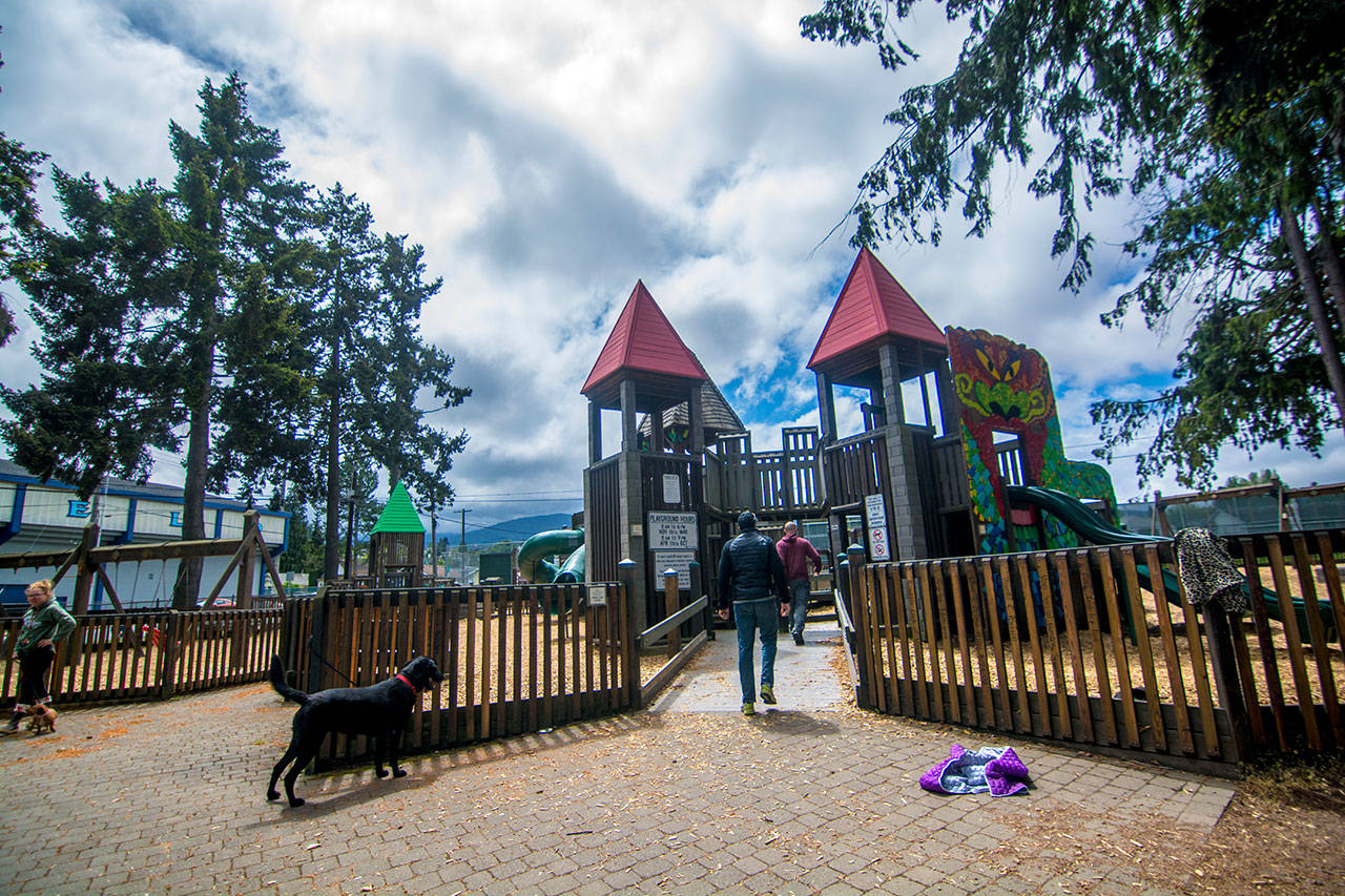 Parents supervise their children at the Dream Playground in Port Angeles on Monday, two days after a child was pricked by a discarded syringe near the park. (Jesse Major/Peninsula Daily News)