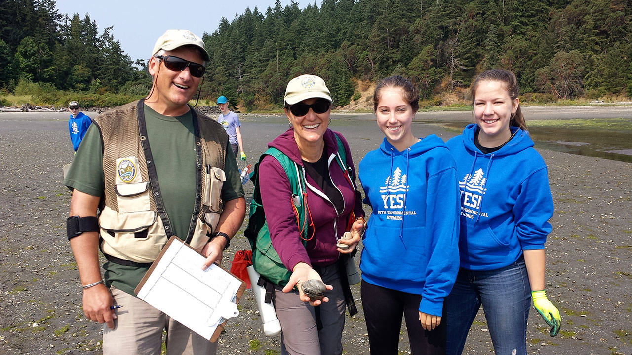 Doug Rodgers and Camille Speck, shellfish biologists with the state Department of Fish and Wildlife, train Elsie McLane and Berit Schultz, both of Port Townsend High School, during the Youth Environmental Stewards Program’s Environmental Science and Leadership Class. (Jude Rubin/Northwest Watershed Institute)