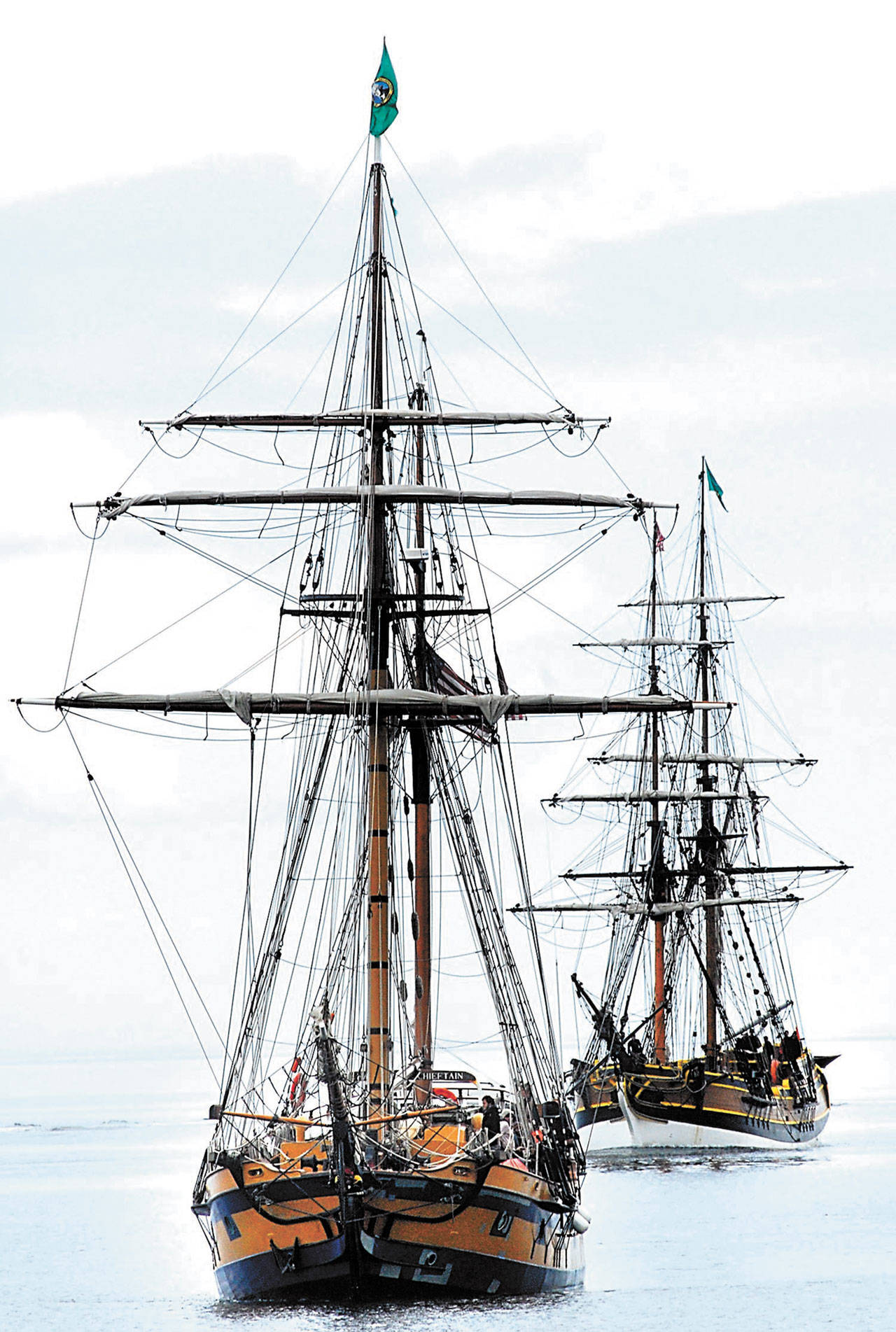 The Hawaiian Chieftain, front, and its sister ship, the Lady Washington, make their way across Port Angeles Harbor to City Pier in 2010. (Keith Thorpe/Peninsula Daily News)
