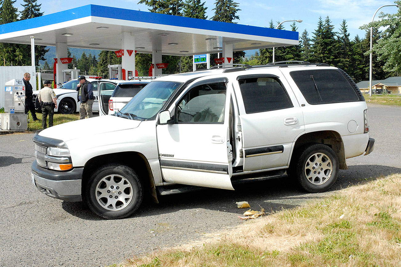 Keith Thorpe/Peninsula Daily News A stolen vehicle involved in a car chase and subsequent foot chase sits at thge Liberty gas station at U.S. Highway 101 and Pioneer Street east of Port Angeles on Saturday morning.