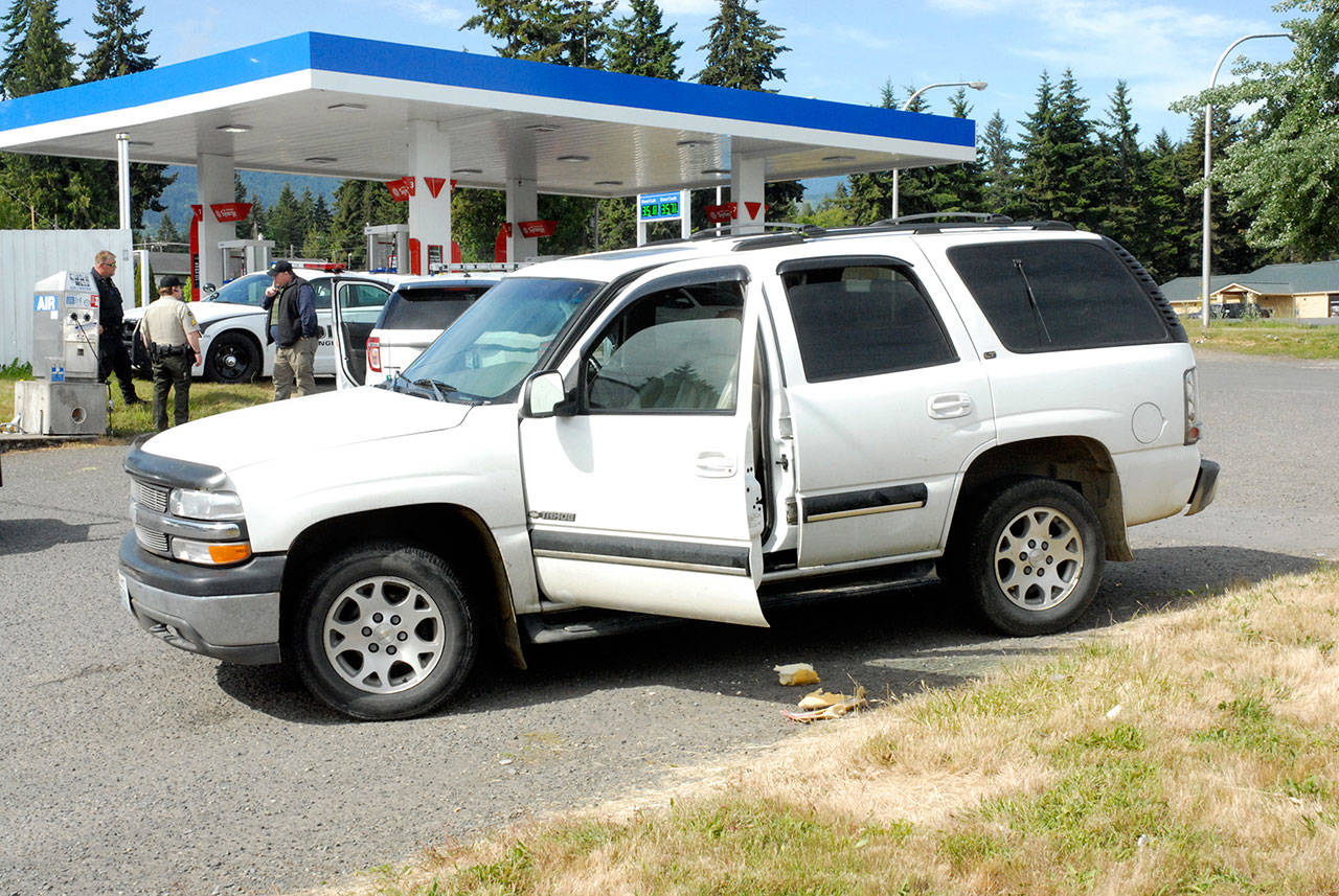 A vehicle involved in a car chase and subsequent foot chase sits at the Liberty gas station at U.S. Highway 101 and Pioneer Street east of Port Angeles on Saturday morning. (Keith Thorpe/Peninsula Daily News)