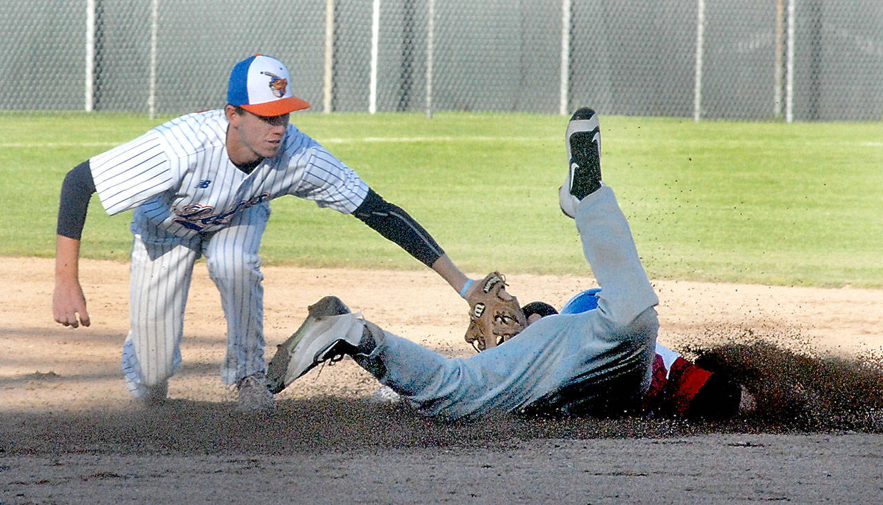 &lt;strong&gt;Keith Thorpe&lt;/strong&gt;/Peninsula Daily News                                Lefties second baseman Trevor Rosenberg, left, tags out Victoria’s Trey Bigford on a steal attempt in the third inning on Thursday night at Port Angeles Civic Field.