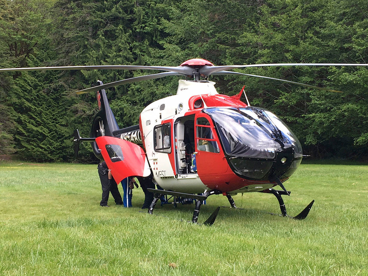 Emergency responders prepare to fly a man to Harborview Medical Center after a wreck on Forest Service Road 2918 on Sunday. (Mike DeRousie/Clallam County Fire District No. 2)