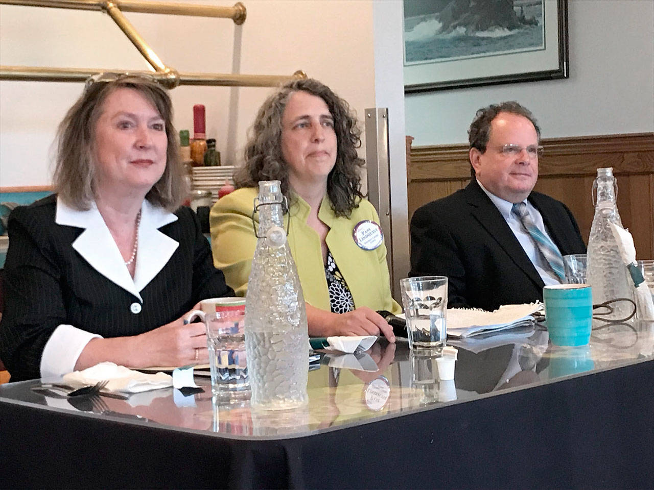District Court 1 candidates, from left, Suzanne Hayden, Pam Lindquist and Dave Neupert listen to the ground rules for their voters forum Tuesday before making presentations and answering questions at the Port Angeles Business Association breakfast meeting. (Paul Gottlieb/Peninsula Daily News)
