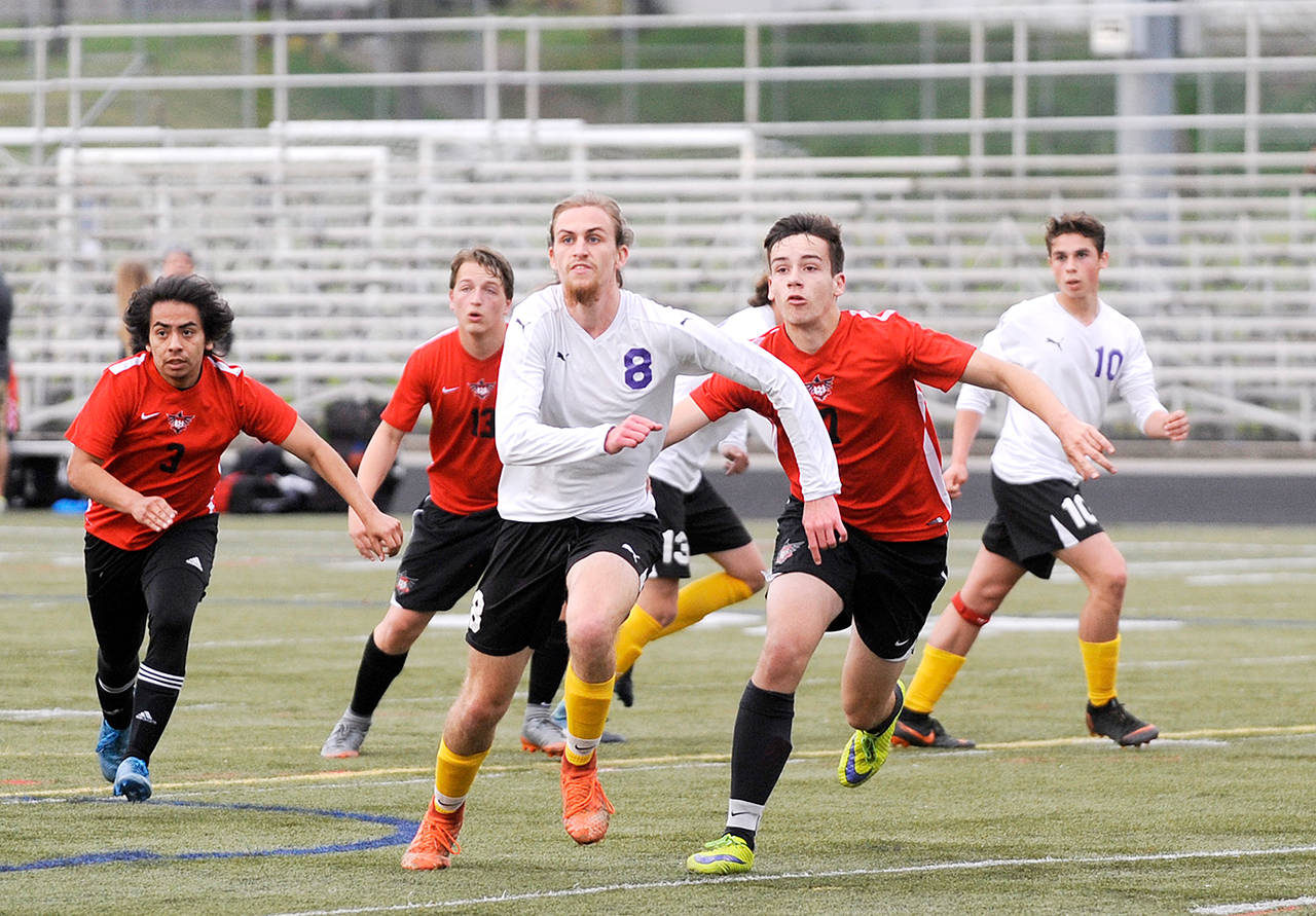 Sequim’s Liam Harris, center, drew a crowd wherever he went on the soccer field. Harris set Sequim’s all-time career goals scored and assist records as a senior.                                Michael Dashiell/Olympic Peninsula News Group