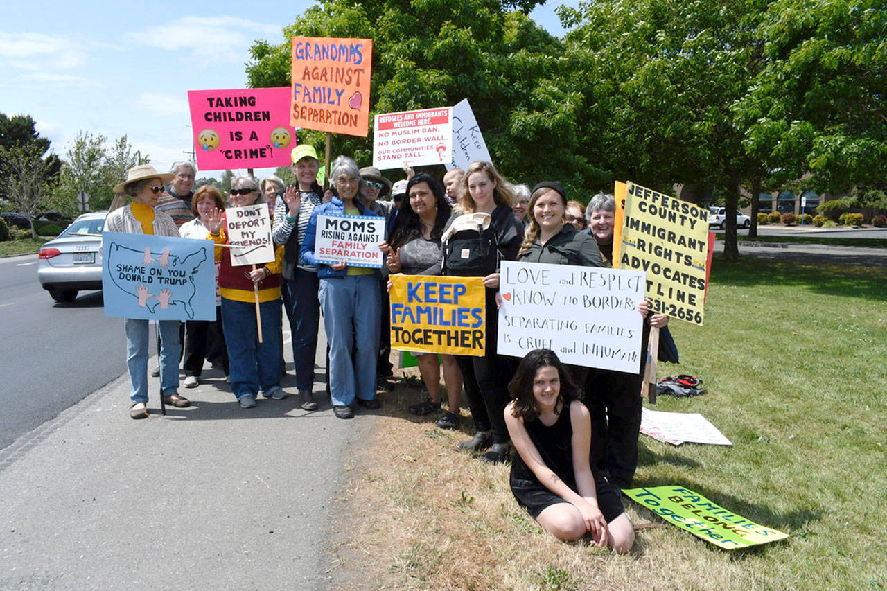 Members of the Jefferson County Immigrant Rights Advocates demonstrate Tuesday to bring attention to the separation of children and their families seeking asylum at the border of the United States and Mexico. (Jeannie McMacken/Peninsula Daily News)