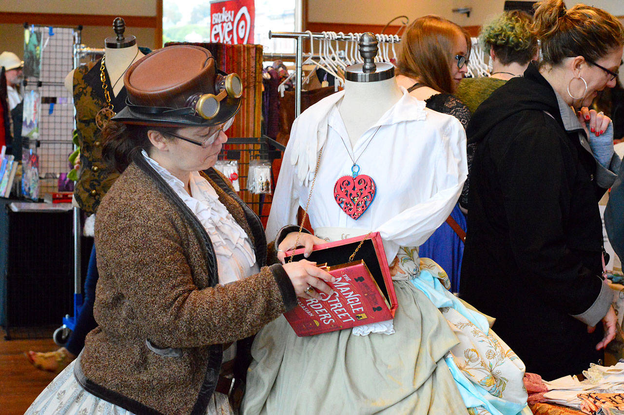 Ashley Mcgehee of Brookings, Ore., made and displayed her Victorian costumes inside the Makers Market at the Northwest Maritime Center on Friday night. The market is open from 10 a.m. to 2 p.m. today at the center in downtown Port Townsend. (Diane Urbani de la Paz/for Peninsula Daily News)