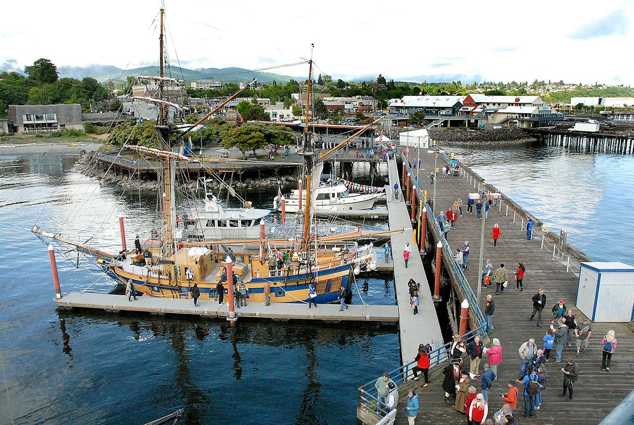 Visitors to the Port Angeles Maritime Festival make their way around Port Angeles City Pier on Saturday to examine ships participating in the event, including the tall ship Hawaiian Chieftain, front. (Keith Thorpe/Peninsula Daily News)