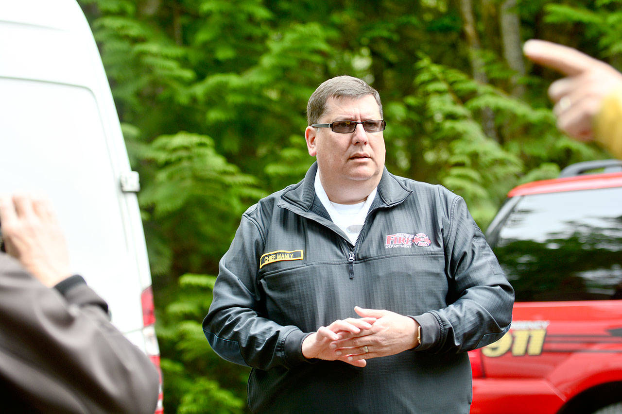 Brinnon Fire Chief Tim Manly speaks to reporters Monday about the fire that killed a family of five early Sunday morning. (Jesse Major/Peninsula Daily News)