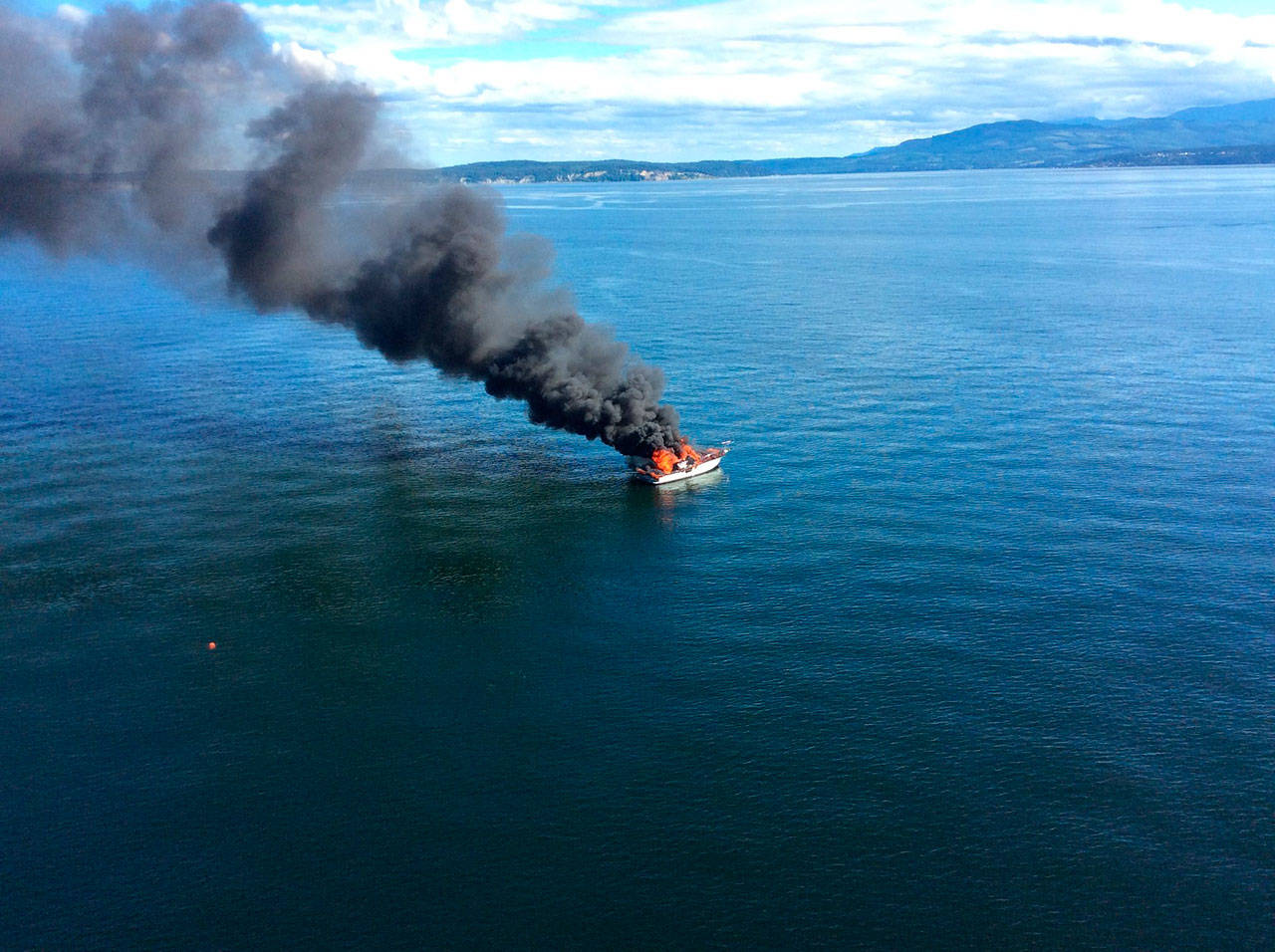 Three boaters on a burning vessel rescued by a good Samaritan vessel Monday and taken to Point Hudson Marina in Port Townsend on a Coast Guard Air Station/Sector Field Port Angeles rescue boat. (U.S. Coast Guard)