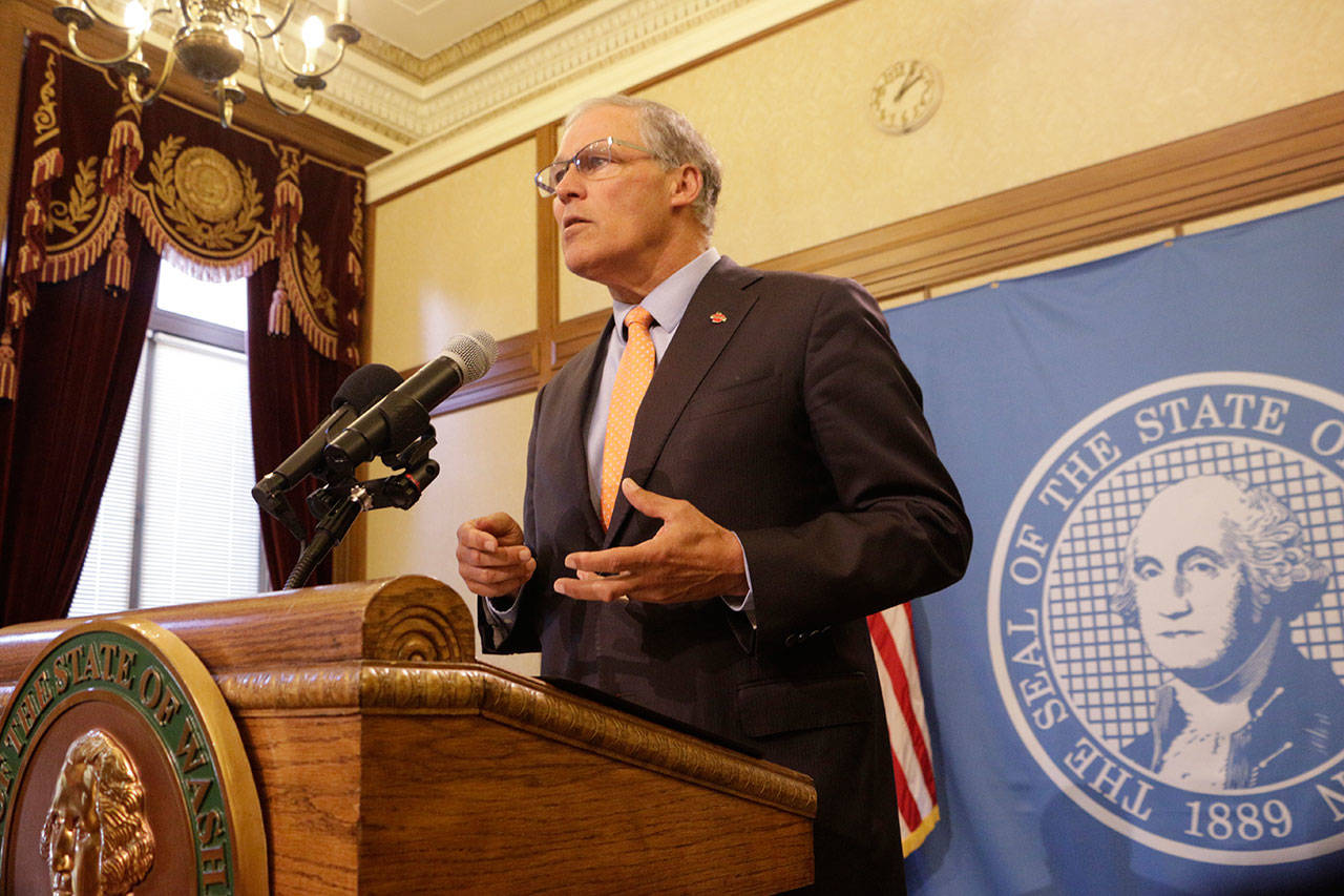 Gov. Jay Inslee talks to the media about emergency funding to support civil legal aid services for immigrant families Wednesday in Olympia. (Rachel La Corte/The Associated Press)