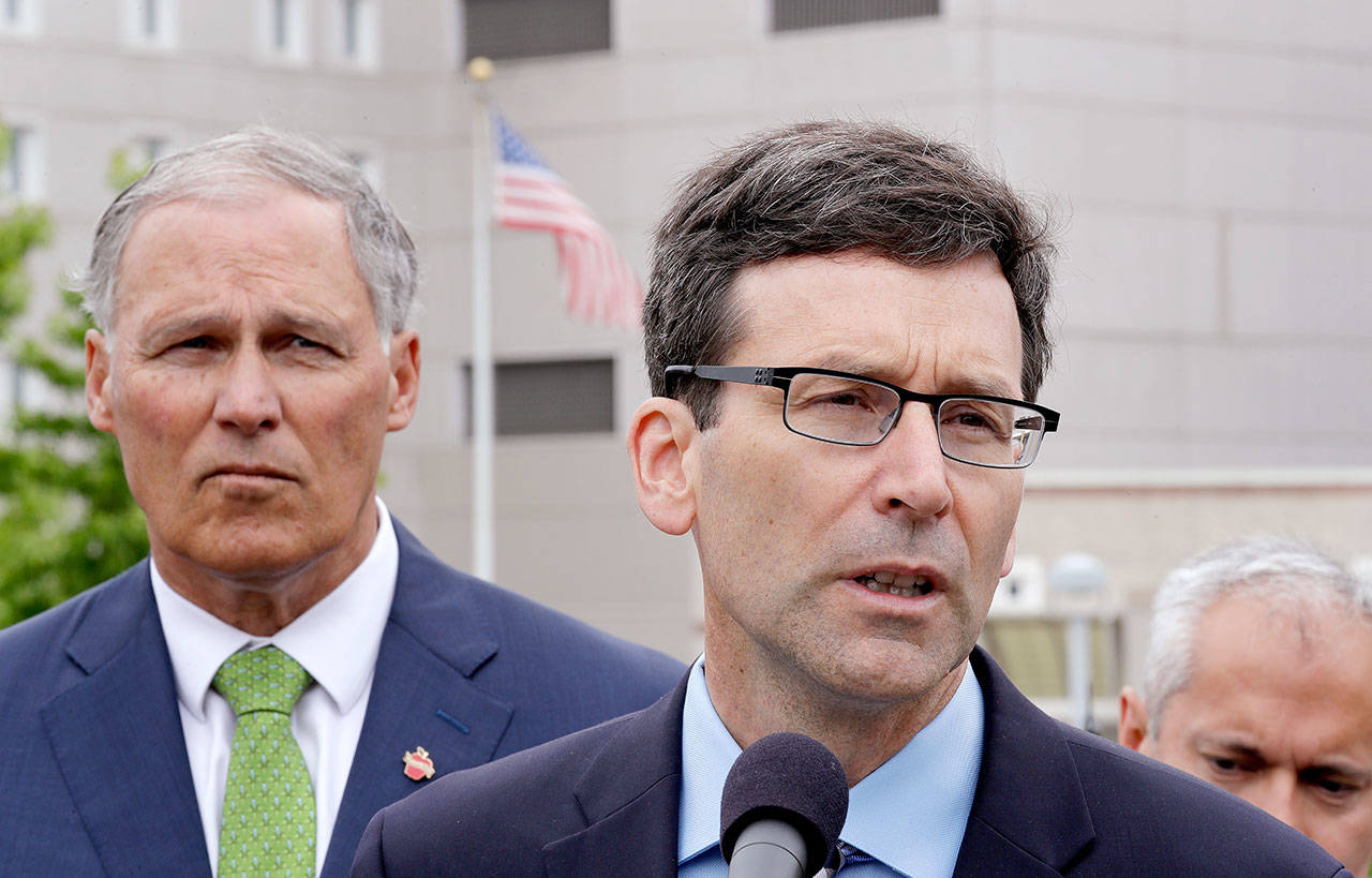 Attorney General Bob Ferguson, right, speaks as Gov. Jay Inslee looks on at a news conference announcing a lawsuit against the Trump administration over a policy of separating immigrant families illegally entering the U.S. (Elaine Thompson/The Associated Press)