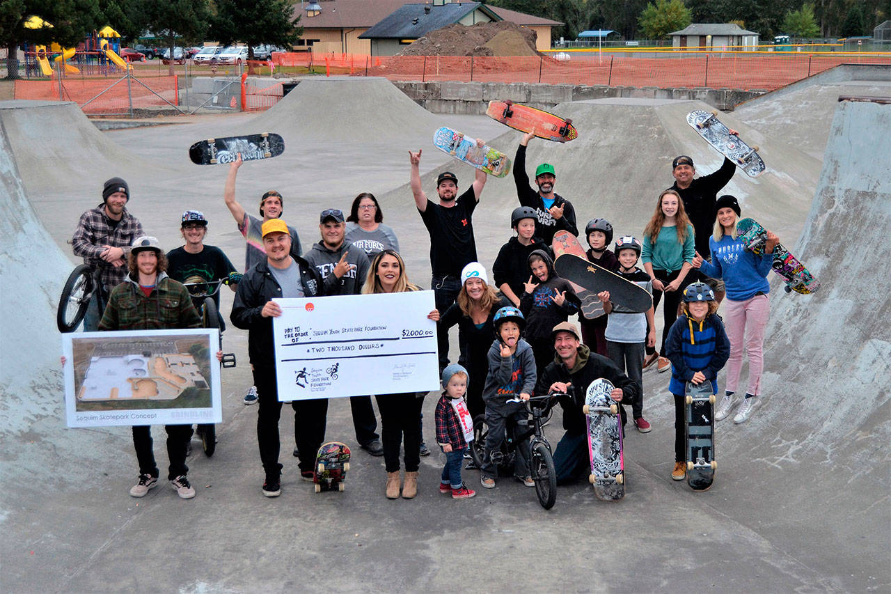 Local riders at Sequim Skate Park gather to accept a $2,000 check on Oct. 6 from the TeamInspire Project, founded by members of the band Emblem3, in 2017. Advocates for the park are raising funds and hosting three contests — skate, bike and scoot — on June 30. (Matthew Nash/Olympic Peninsula News Group)