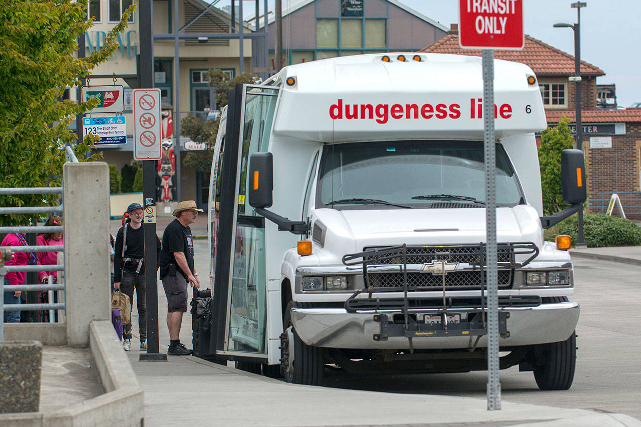 Passengers load onto the Dungeness Line bus at the Gateway Transit Center in Port Angeles on Thursday. Greyhound Lines will take over the route starting Sunday. (Jesse Major/Peninsula Daily News)