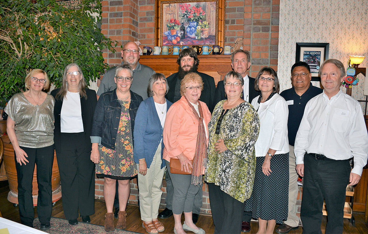 Front row, from left, Carol Jackson, Pam Munro, Laura Knowles, Diana Tschimperle, Barb Gapper, Linda Waknitz, Vicki Anderson, Buddy Bear, and Barry Burnett; back row, from left, Michael Knowles, Dennis McCarthy, and Marc Jackson. Not pictured: Janis Bane, Grace Clawson, Pamela Kiteley, Darrell Little, Julie Rael, Deborah Rich, Kathleen Schmidt, and Tina Smith. (Patsene Dashiell/Port Angeles School District)