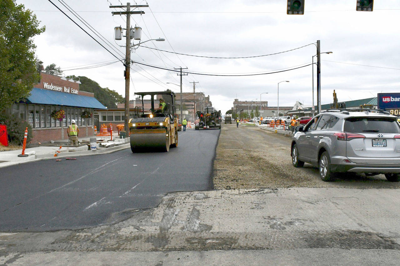 Crews from Lakeside Industries work Thursday to complete paving of the last section of Water Street while rollers compact the freshly applied asphalt. The road bed on the south side of the street awaits its final application on Monday. The final step will be striping the lanes and parking spots. (Jeannie McMacken/Peninsula Daily News)