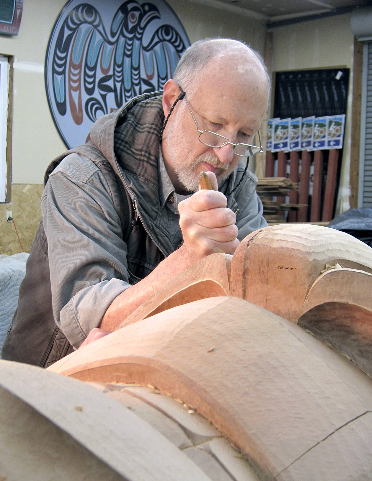 Dale Faulstich, pictured here working on a a totem pole, will tell of the making of Sequim totem pole tonight