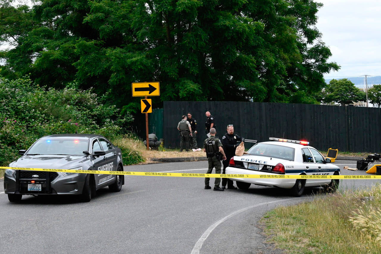 Port Townsend police and the Jefferson County Sheriff’s Office collect evidence Sunday morning after a stabbing behind Memorial Field in Port Townsend. (Jeannie McMacken/Peninsula Daily News)