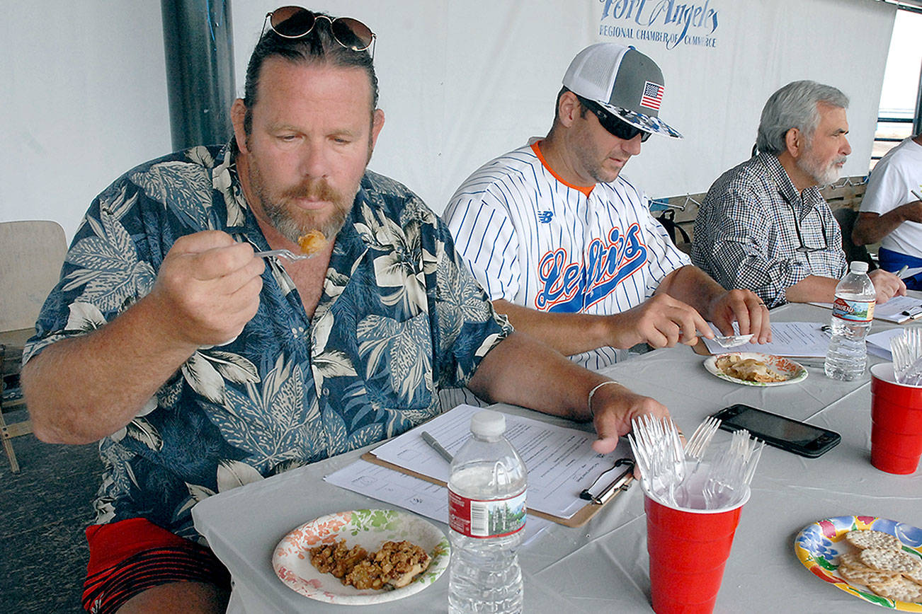Keith Thorpe/Peninsula Daily News Port Angeles artist and pie judge Jeff Tocher, left, along with fellow judges Darren Westergard, coach of the Port Angeles Lefties, and John Brewer, community volunteer and former Peninsula Daily News publisher, taste samples of apple pie during Wednesday’s Independence Day &quot;Pies on the Pier&quot; contest.