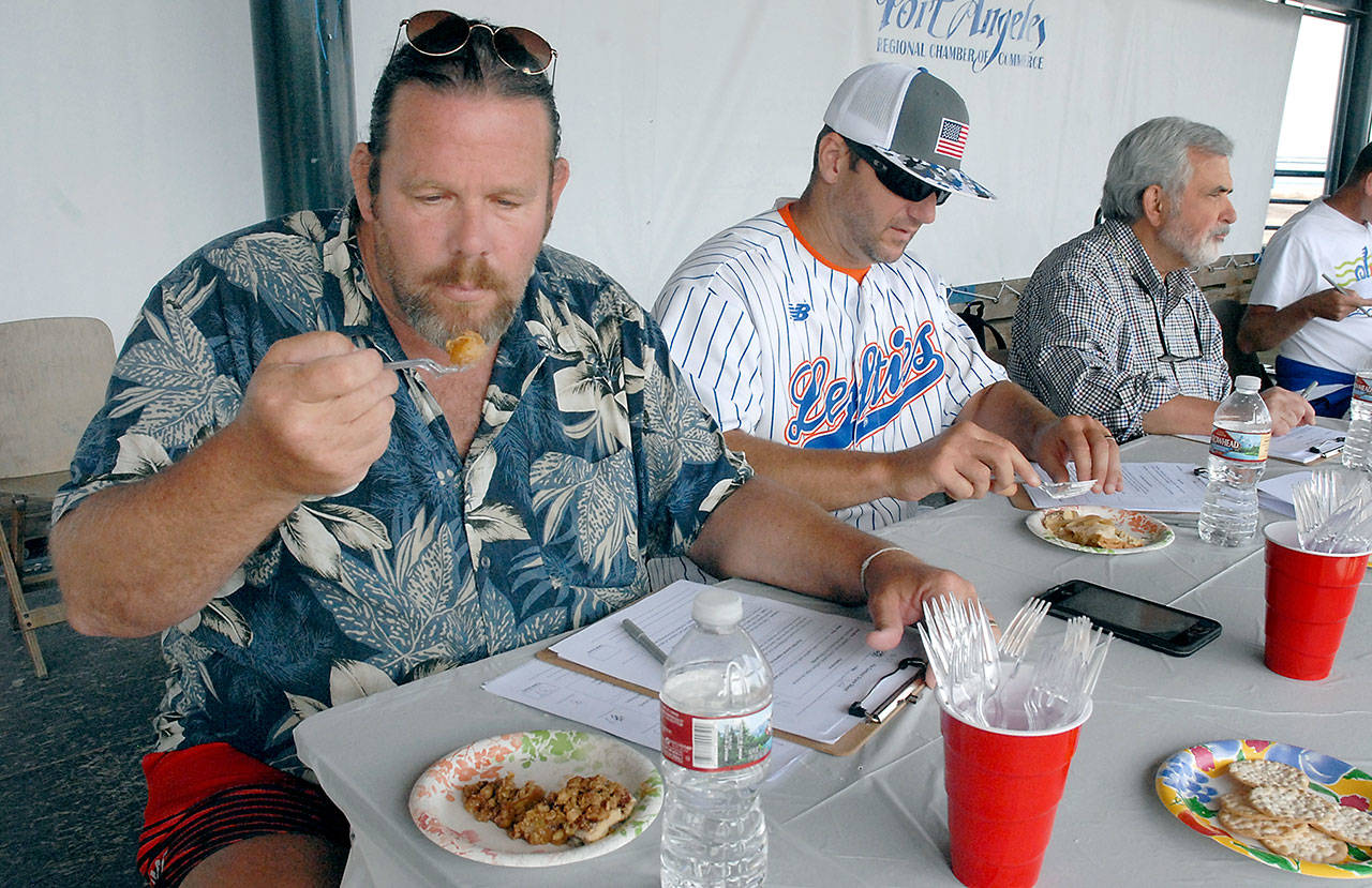 Port Angeles artist and pie judge Jeff Tocher, left, along with fellow judges Darren Westergard, coach of the Port Angeles Lefties, and John Brewer, community volunteer and former Peninsula Daily News publisher, taste samples of apple pie during Wednesday’s Independence Day “Pies on the Pier” contest. (Keith Thorpe/Peninsula Daily News)                                Port Angeles artist and pie judge Jeff Tocher, left, along with fellow judges Darren Westergard, coach of the Port Angeles Lefties, and John Brewer, community volunteer and former Peninsula Daily News publisher, taste samples of apple pie during Wednesday’s Independence Day “Pies on the Pier” contest. (Keith Thorpe/Peninsula Daily News)