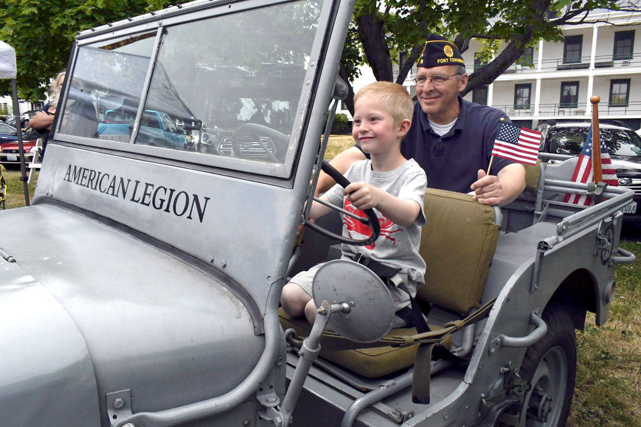 As part of Port Townsend’s Old School 4th of July festivities at Fort Worden, Marine veteran Bob Saring of Port Townsend sits with nephew Chance McFarland in a World War II Navy Jeep that was restored by a member of the local American Legion. (Jeannie McMacken/Peninsula Daily News)