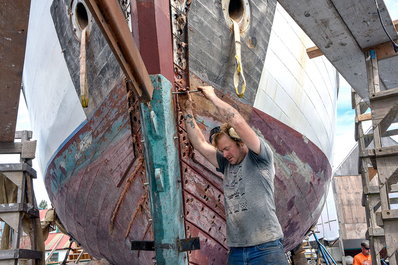 An example of marine trades work done in Port Townsend is shipwright Emil Africa working on the bow of the schooner W.N.Ragland, owned by Neil Young, which is undergoing repair at Haven BoatWorks, LLC. (© Bill Curtsinger, Port Townsend Marine Trades Association)