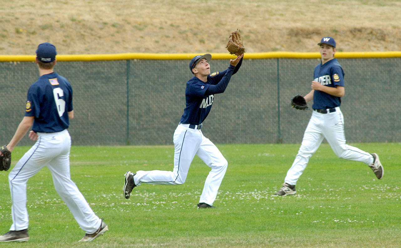 Keith Thorpe/Peninsula Daily News Wilder Junior outfielder Tanner Price, center, gets under an incoming fly while flanked by teammates Wyatt Hall, left, and Timmy Adams in the first game of Saturdays double-header against Mount Vernon at Volunteer Field in Port Angeles.