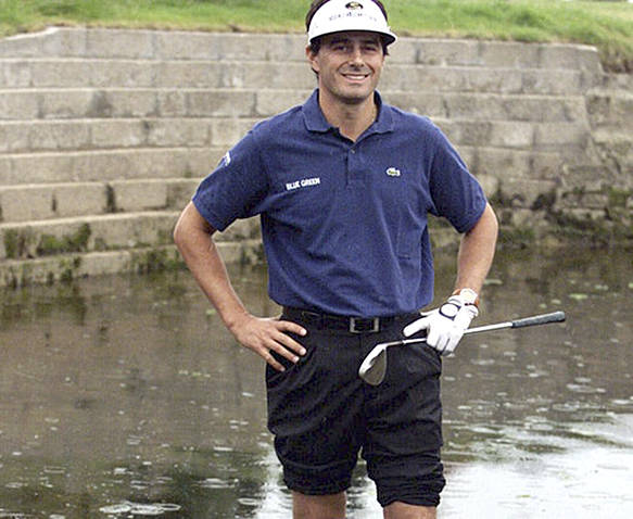 The Associated Press                                In this July 18, 1999, file photo, France’s Jean Van de Velde smiles as he stands in the water of the Barry Burn that crosses the 18th fairway to see if his ball was playable during the final round of the 128th British Open at Carnoustie.