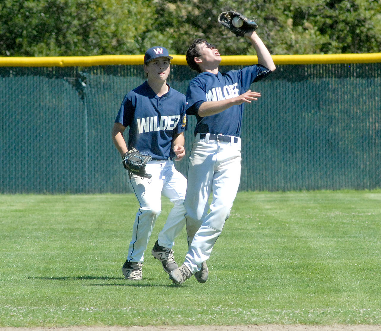 Keith Thorpe/Peninsula Daily News Wilder second baseman Michael Grubb, right, drops back to catch a fly ball while center fielder Timmy Adams backs him up during a game against Lower Columbia.