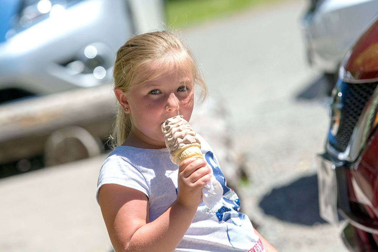 Agnes Huff, 5, enjoys a half-and-half ice cream cone from Granny’s Cafe on Thursday. (Jesse Major/Peninsula Daily News)