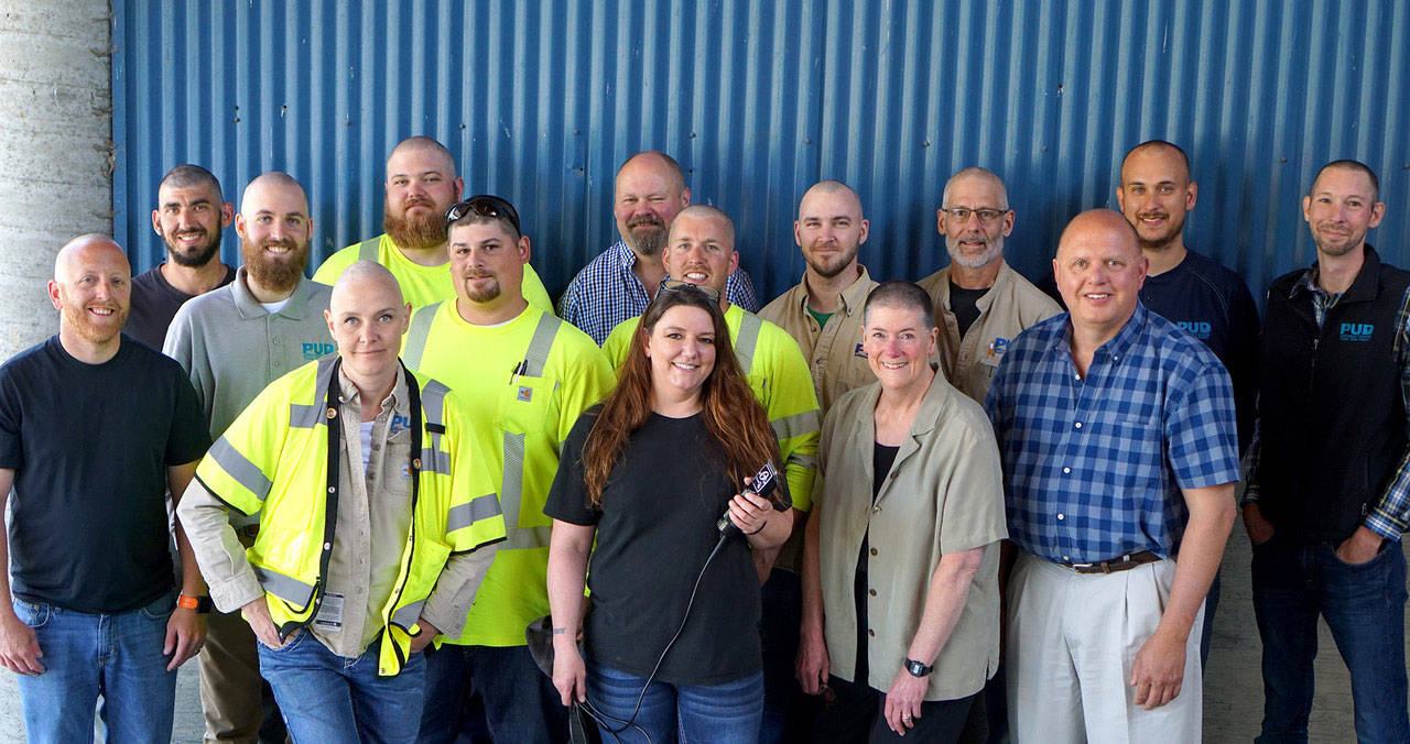 Marianne Kline, front left, is flanked by some of her Jefferson County PUD colleagues who shaved their heads in support of her battle with cervical cancer. General Manager Larry Dunbar, front right, stepped up to the challenge, as did all three PUD commissioners. (Jefferson County PUD)