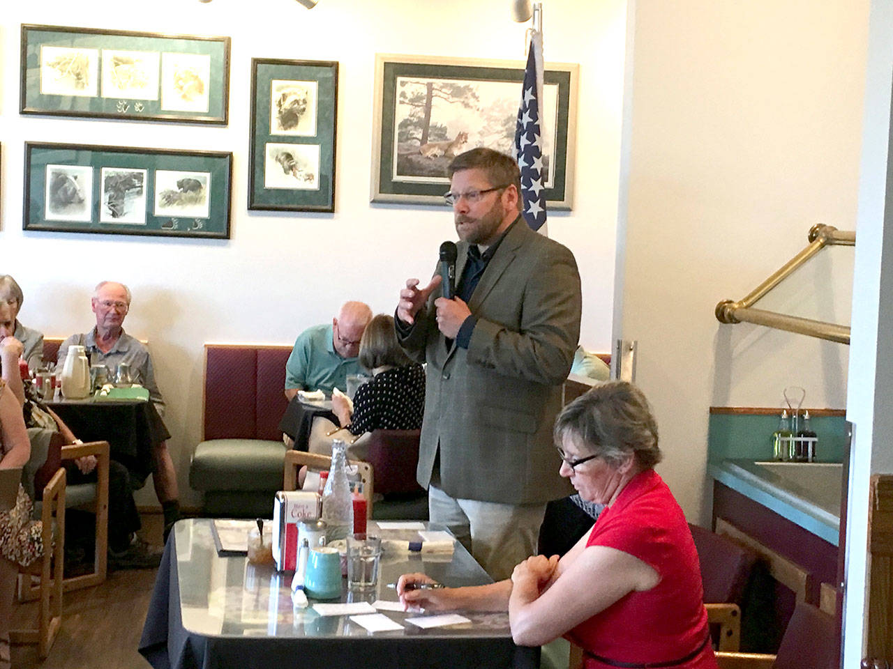 State Rep. Mike Chapman speaks at a candidate’s forum at Joshua’s Restaurant in Port Angeles on Tuesday. Chapman, D-Port Angeles, is running against Port Townsend Republican Jodi Wilke, seated, in the November election. (Rob Ollikainen/Peninsula Daily News)
