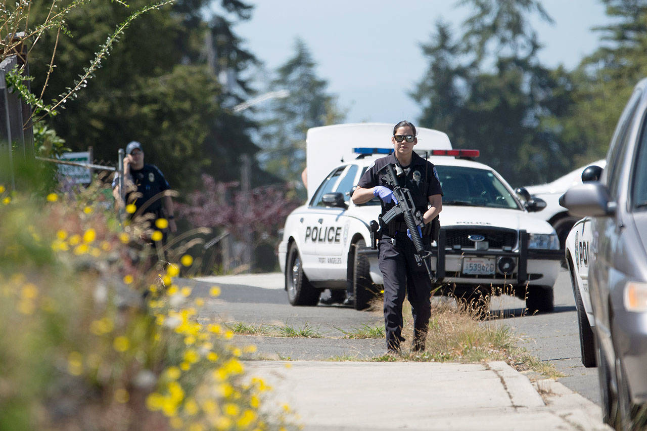 Port Angeles police carried rifles as they attempted to serve a warrant on the 1600 block of West Seventh Street on Wednesday. (Jesse Major/Peninsula Daily News)