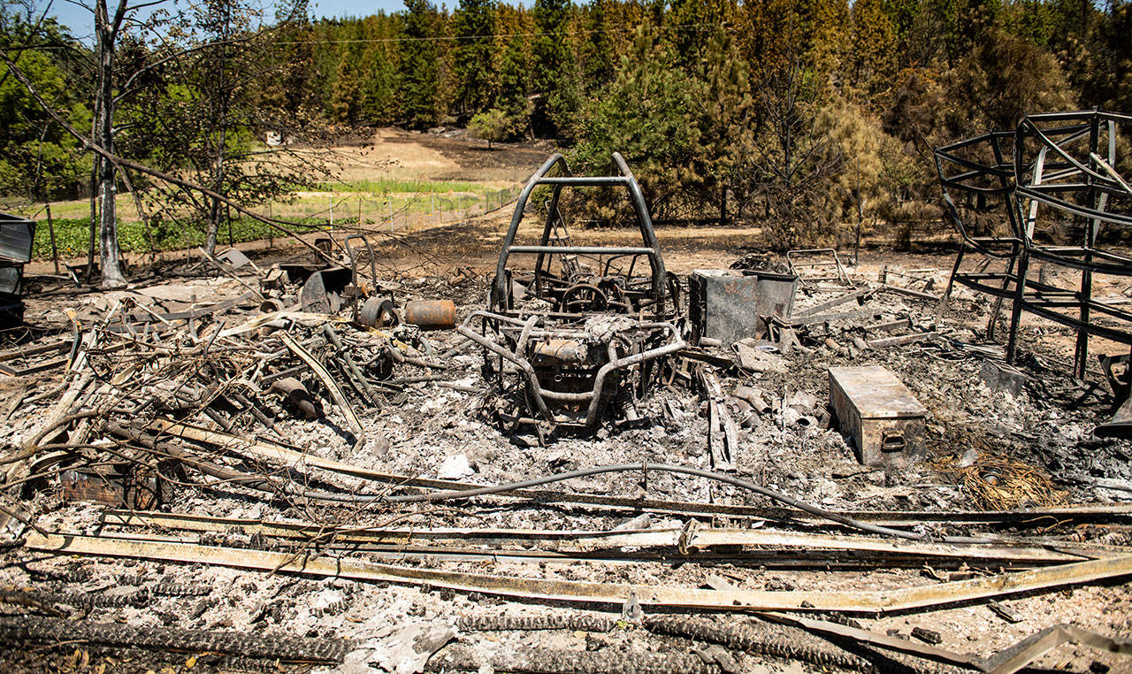 Just north of Upriver Drive, charred remains is all that is left of this garage Wednesday that burned during Tuesdays wildfire. (Colin Mulvany/The Spokesman-Review via AP)