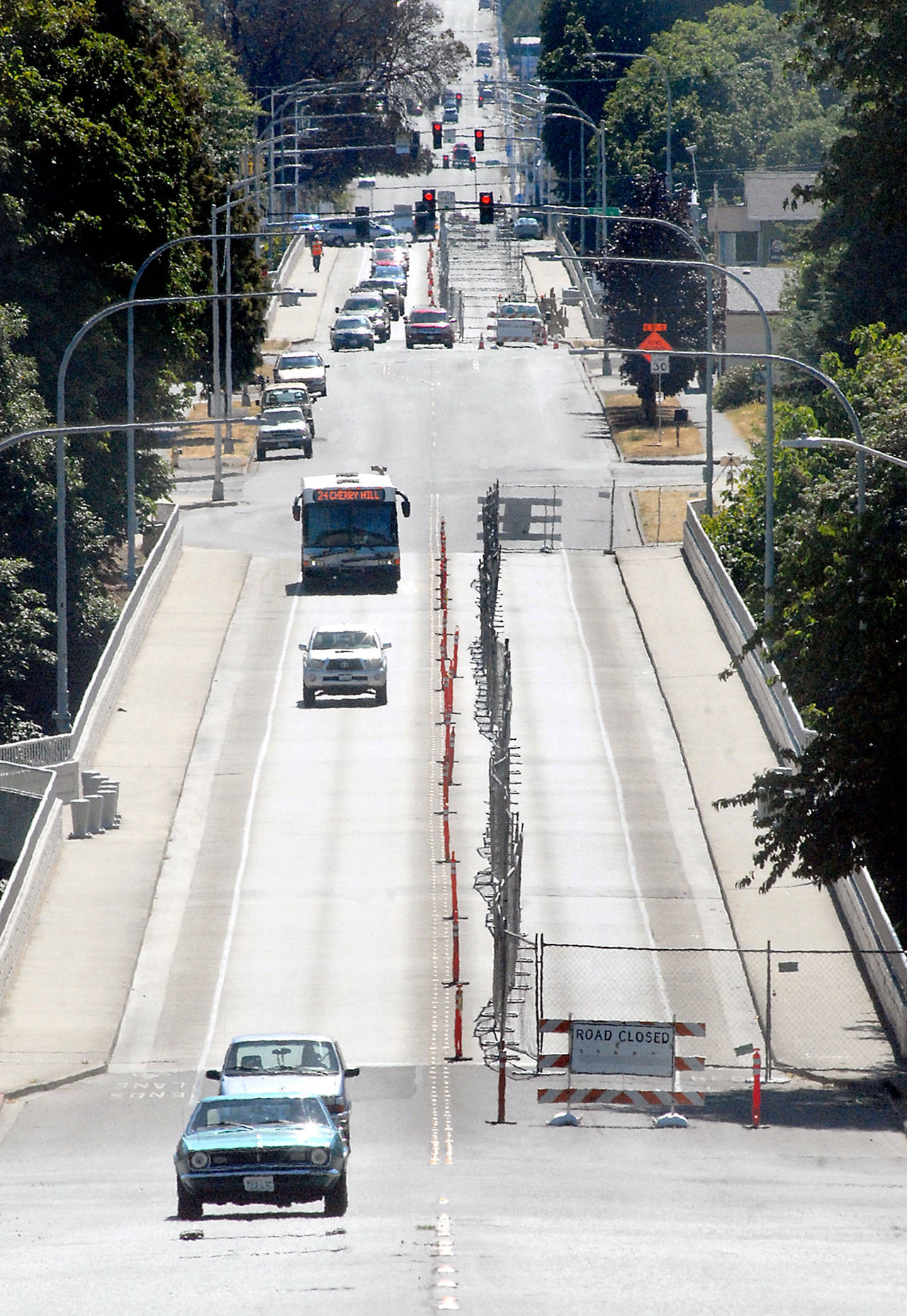 Construction fencing and traffic cones mark lane closures on the Eighth Street bridges over Tumwater and Valley creeks in Port Angeles on Thursday as crews prepare to install new railings on the spans. (Keith Thorpe/Peninsula Daily News)