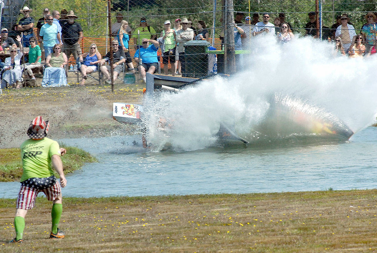 Keith Thorpe/Peninsula Daily News A 400-class sprint boat piloted by Jake Warner and navigated by Joe Goranson of Vancouver, B.C.-based Fat Buddy Racing flips into the water while navigating a turn during Saturday’s preliminary races at the Extreme Sports Park in Port Angeles. The pair was uninjured in the crash.