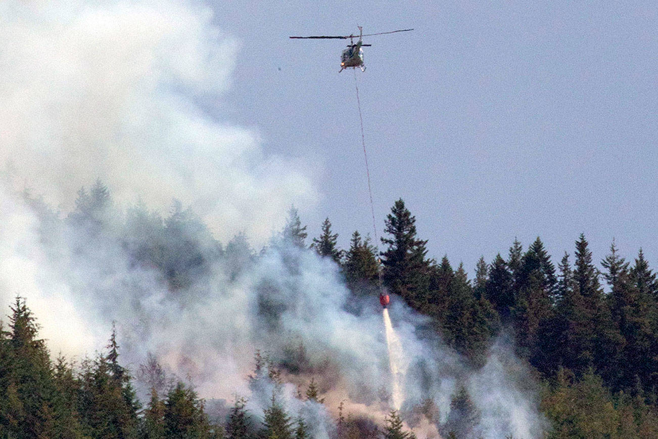 At least one helicopter assisted with water drops on the Blyn fire on Friday. (Robert Steelquist)