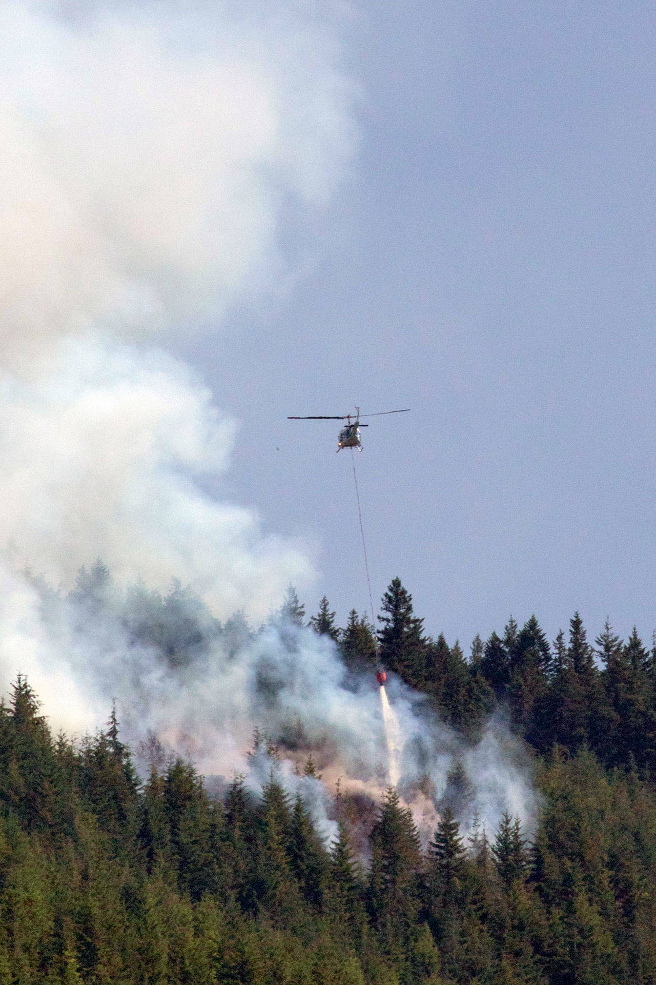 At least one helicopter assisted with water drops on the Blyn fire on Friday. (Robert Steelquist)