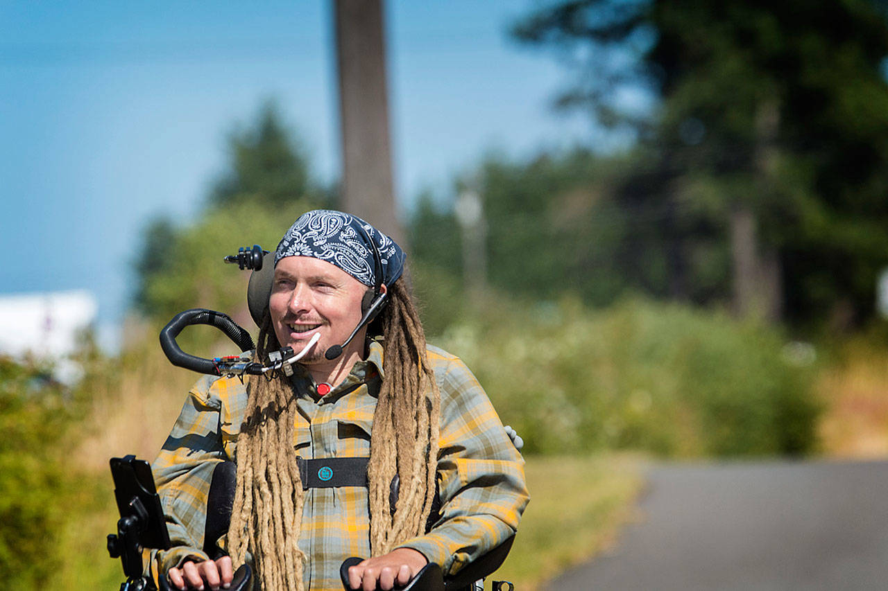 Ian Mackay, who is preparing to ride his wheelchair from Coeur D’Alene, Idaho, to his home in Agnew next month, rides along the Olympic Discovery Trail on July 18. In 2016, Mackay rode his wheelchair from Port Angeles, through part of British Columbia and south to Portland, Ore., raising international attention to the need for accessible trails. (Jesse Major/Peninsula Daily News)