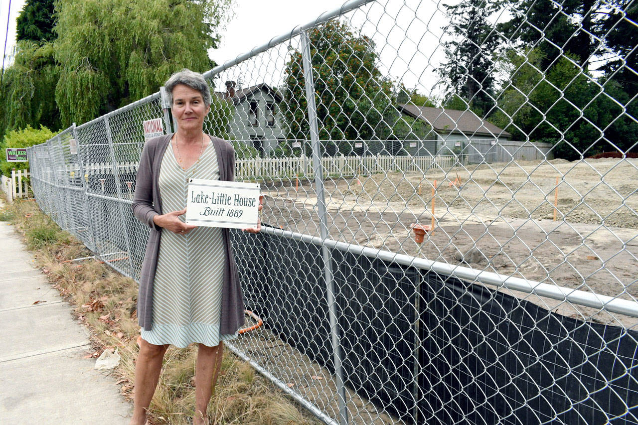 Julia Rouse owns a home whose backyard now bumps up against a staff parking lot across the street from Salish Coast Elementary School. Rouse acknowledged the school district has worked to mitigate the intrusion, but feels the city is not addressing larger issues, altering the character of the greater Castle Hill neighborhood. (Jeannie McMacken/Peninsula Daily News)