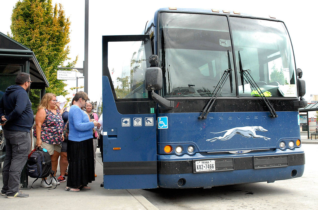 Passengers board the Dungeness Line to Seattle and Sea-Tac International Airport on Thursday at The Gateway transit center in Port Angeles. (Keith Thorpe/Peninsula Daily News)