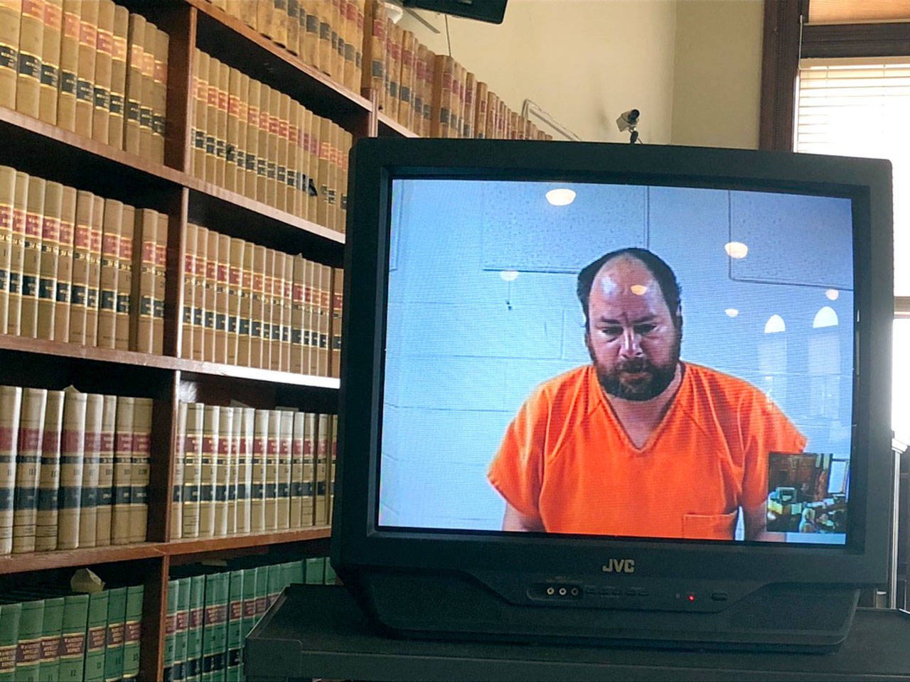 Brandon B. Smith, a transient man, allegedly attacked a woman at a homeless camp in Port Townsend on Tuesday. He is shown on a television monitor at his court appearance. (Jeannie McMacken /Peninsula Daily News)