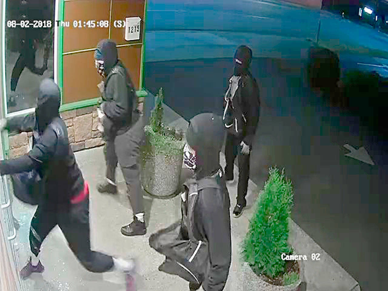 Port Angeles police released this surveillance photo of four men wanted for the burglary of two marijuana stores. (Port Angeles Police Department)