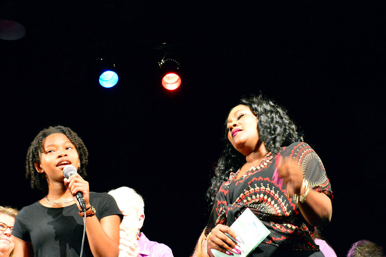 Tiffani Jones, 16, of Des Moines, Wash., left, sang with Tawana Cunningham of Memphis, Tenn., in the free gospel concert Saturday morning at Fort Worden State Park’s Wheeler Theater. An overflow crowd jammed the the event, part of the Acoustic Blues Festival that wrapped up Saturday night. (Diane Urbani de la Paz/for Peninsula Daily News)