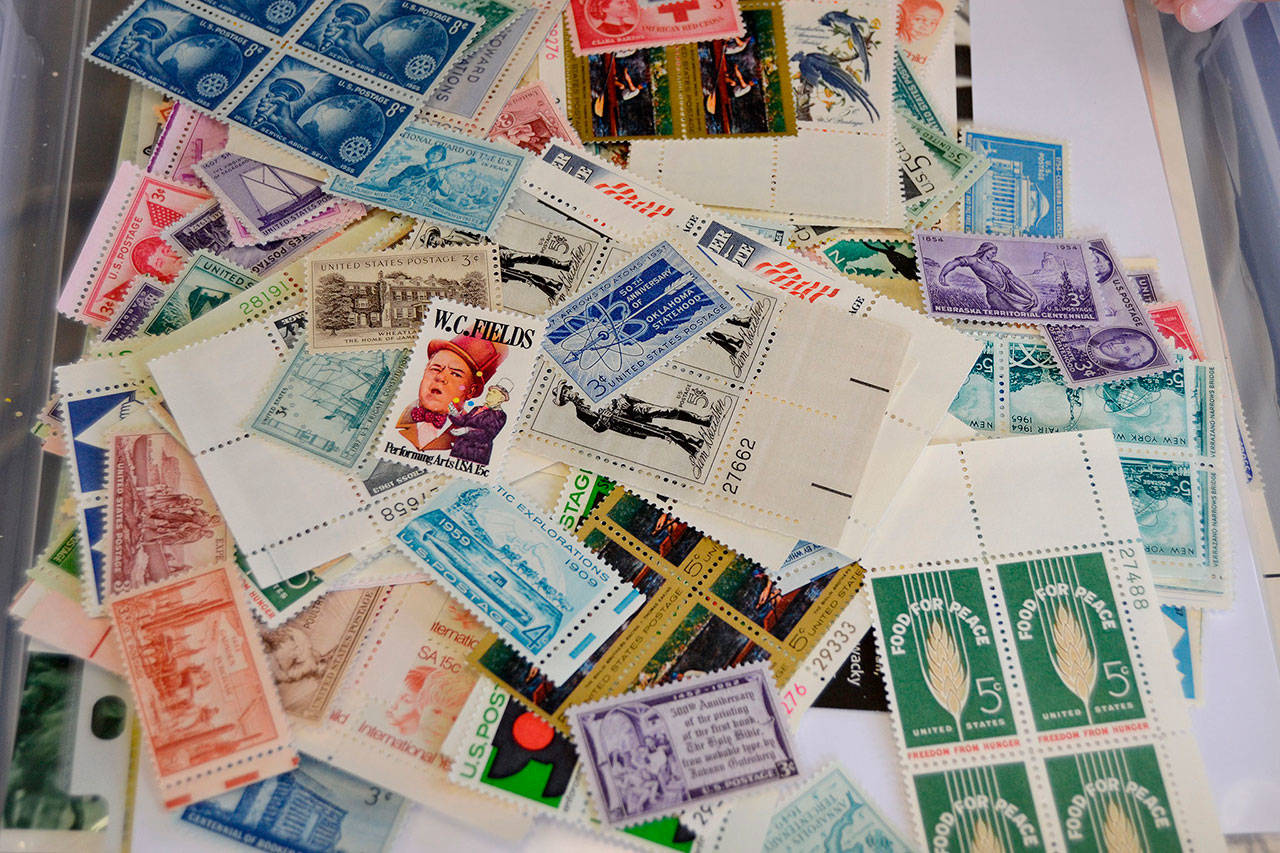 Henry Jones creates a “My Post Office” assortment of collector’s stamps totaling about $50 in mailable stamps. He plans to auction off the collections at the Rotary Club of Sequim’s Salmon Bake on Sunday. (Matthew Nash/Olympic Peninsula News Group)