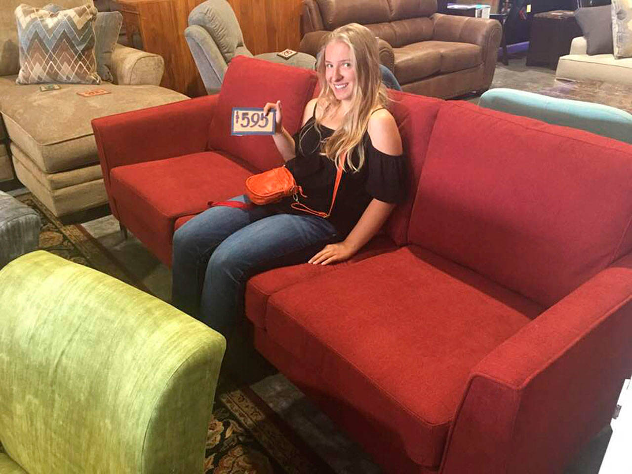 The “Night at the Museum” fundraiser event Sunday is raising monies for the Robby Streett Legacy Fund to purchase new furniture for the Sequim High School library, in honor of Robby Streett. Annie Armstrong, one of the organizers of the event, sits on a couch at The Warehouse in Port Angeles in search of new furniture.