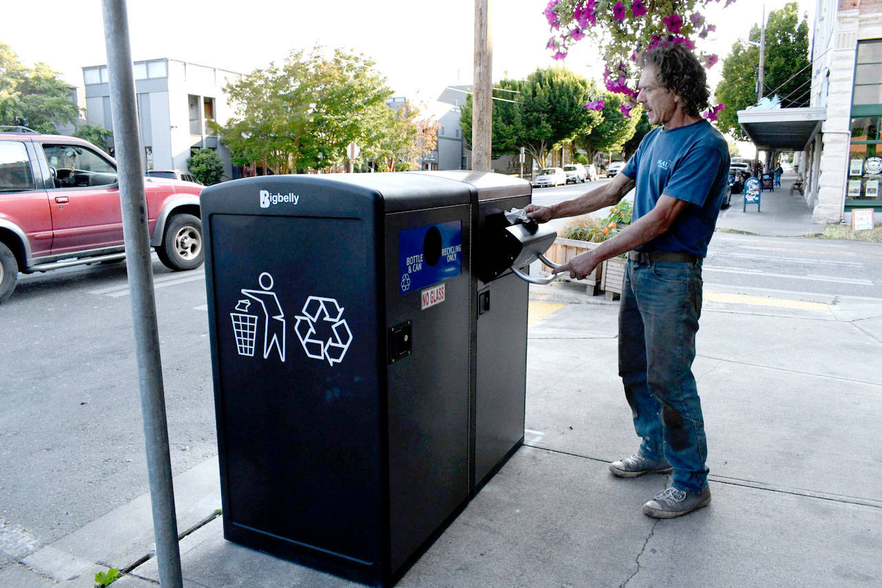 At the Aldrich’s Market uptown location, Port Townsend’s Jim Rondeau said he likes the fact that the compactor has solar technology that allows it to hold more trash than a conventional bin and alerts collectors when the bins are ready to be emptied. (Jeannie McMacken/Peninsula Daily News)