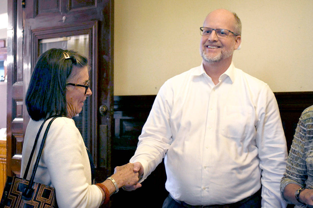 Chimacum School District Superintendent Rick Thompson is congratulated by Jefferson County Commissioner Kathleen Kler as he learns that the $7.95 million capital levy was passed by district voters. (Jeannie McMacken/Peninsula Daily News)